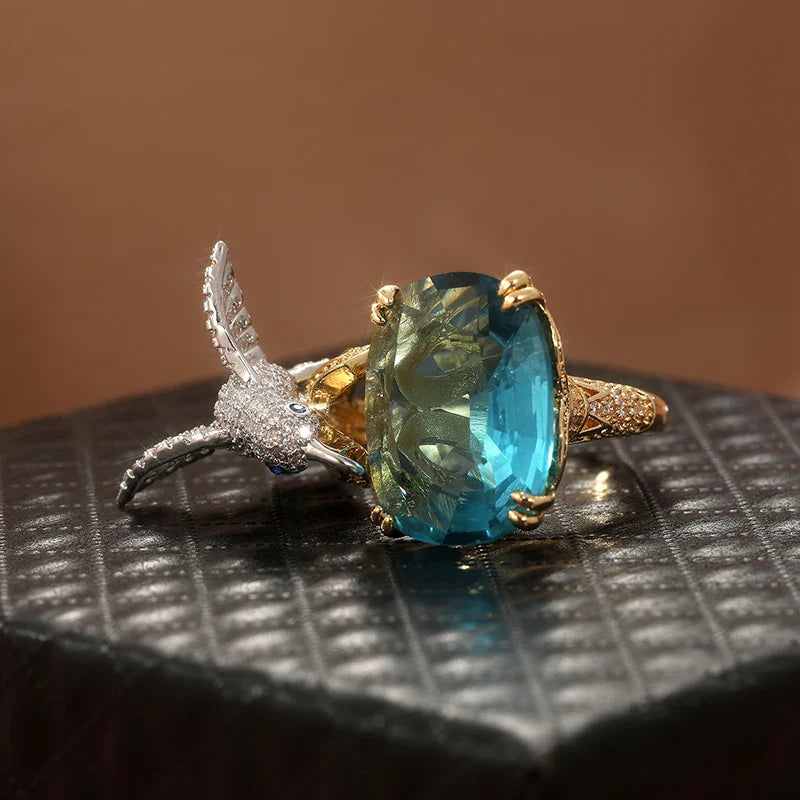 Anello Regolabile Colore Acquamarina con Colibrì – Placcato Oro